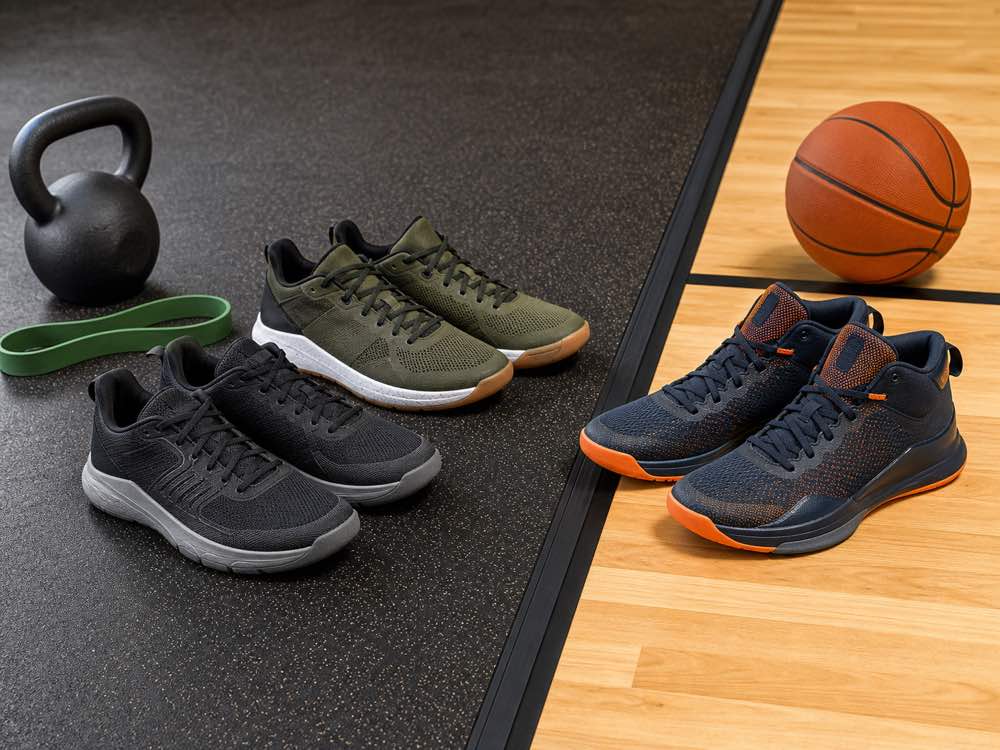 Unbranded training and basketball shoe pairs arranged across gym and court surfaces