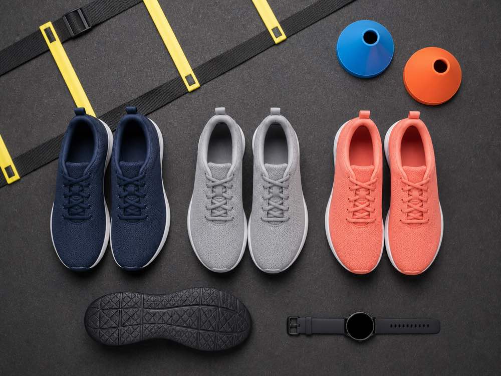 Three unbranded training shoe pairs with agility ladder cones and multidirectional outsole